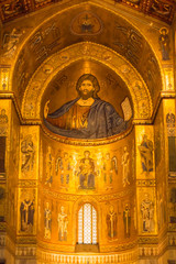Fototapeta na wymiar Christ Pantocrator central apse in gold in the Santa Maria Nuova cathedral