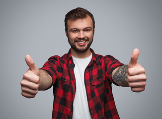 Cheerful hipster showing thumbs up