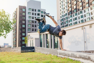 Skateboarder handstand on ramp