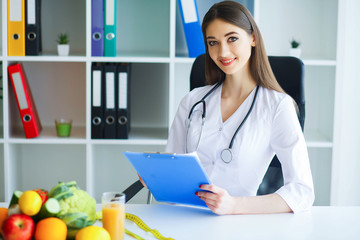 Health. Diet and Healthy. Nutrition. Portrait of a Dietitian's Doctor with Fresh Fruits and...