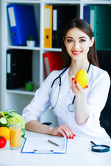Health. Diet and Healthy. Nutrition. Portrait of a Dietitian's Doctor with Fresh Fruits and...