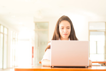 Fototapeta premium beautiful indian college girl using laptop (with selective focus)