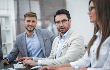 close up.businessman and employees sitting at the Desk