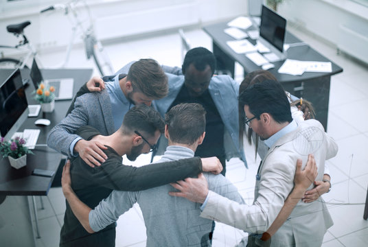 Group Of Successful Business People Hugging Each Other