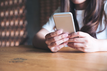 Closeup image of a woman holding , using and touching a smart phone