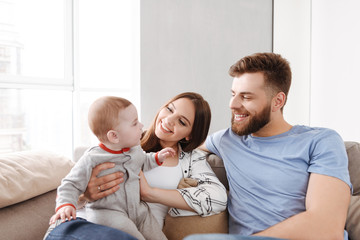 Couple parents having fun with their little child son.