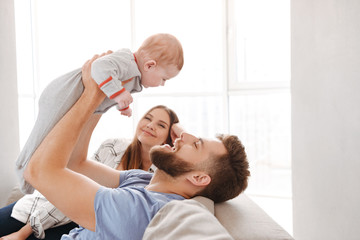 Couple parents having fun with their little child son.
