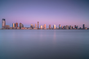 View on Jersey city from water during sunrise from