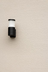 Modern lamp on cement wall