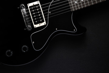 Fototapeta premium black electric guitar on a black
