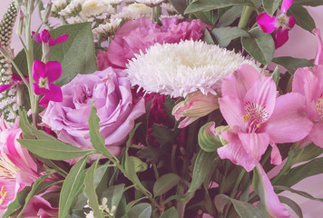 Beautiful flower bouquet on a pink background, close-up