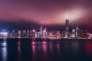 Hong Kong skyline on Victoria Harbour with moody mist and clouds in sky