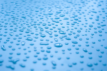 Water droplets on blue background