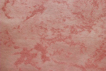 Abstract texture of decorative plaster. Grunge background of stucco texture. Red grained surface.