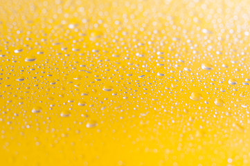 Water droplets on yellow background.