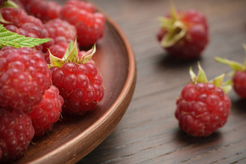 Red raspberries in a plate. Closeup, Garden Berries