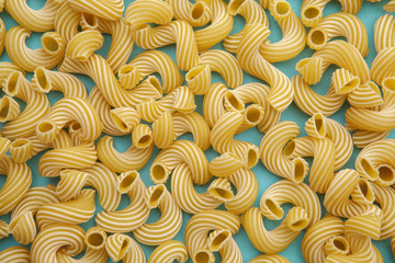 background of pasta in the form of tubes spun in a spiral
