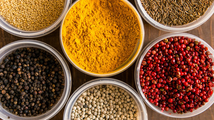 Various colorful spices in plastic containers