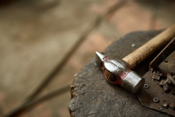 Working metal tools in blacksmith's workshop, close-up, selective focus, nobody