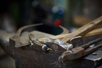 Working metal tools in blacksmith's workshop, close-up, selective focus, nobody