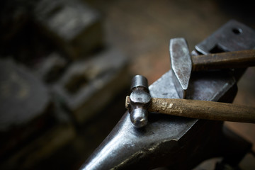 Working metal tools in blacksmith's workshop, close-up, selective focus, nobody