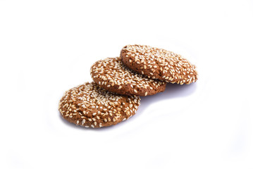 Three oatmeal cookies with sesame seeds isolated on white backgr