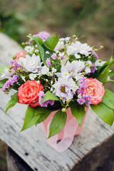 Bouquet in a box, on a wooden bench