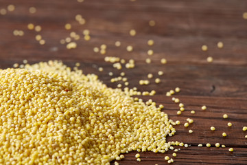 Lentils in a wooden bowl on rustic wooden background, top view, close-up, selective focus.