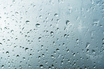 Textured background of window panes with a cloudy background. Natural pattern from a drop of rain...