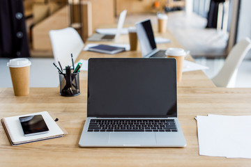 laptops and smartphone on tables in business office