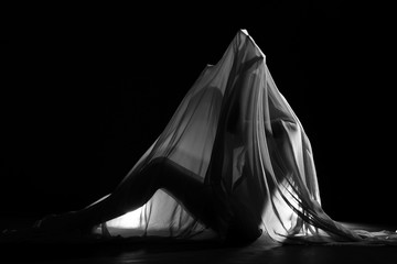 sensual sexy look of beautiful figure girl under hiding in light thin fabric, to show silhouette of woman body lying on floor