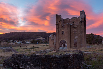 A sunrise over the iconic Lithgow Ironworks blast furnace in the blue mountains of New South Wales...