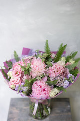 Work florist. Beautiful spring bouquet. Arrangement with mix flowers. The concept of a flower shop, a small family business. Pastel Color.