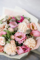 Work florist. Beautiful spring bouquet. Arrangement with mix flowers. The concept of a flower shop, a small family business. Pastel Color.