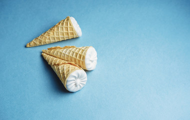 ice cream on a blue background, three wafer horns, top view, place for text