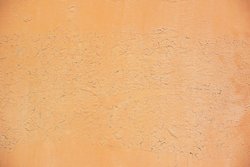 Photo of the yellow colored rough, grunge stucco wall texture