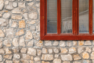Fragment masonry stone wall with grunge wood window
