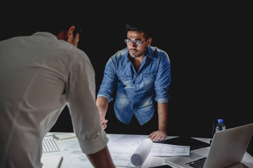 Architect team discussing project at night