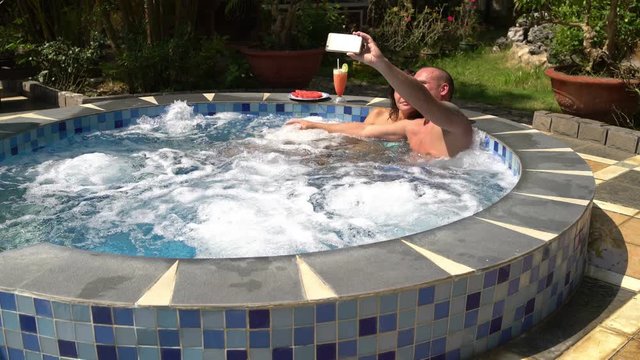 Couple makes selfi in hot tub