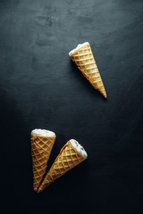 ice cream on a black background, three wafer horns, top view,