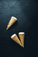 ice cream on a black background, three wafer horns, top view,