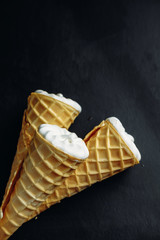 ice cream on a black background, three wafer horns, top view,
