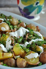Potato salad with dill on a white platter