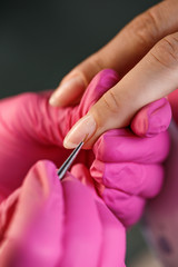 beautician applying Polish nails