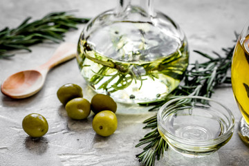 olive oil with ingredients on kitchen table background