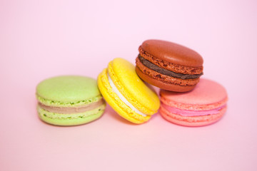 Macaroon biscuits on pastel pink background, beautiful sweet food