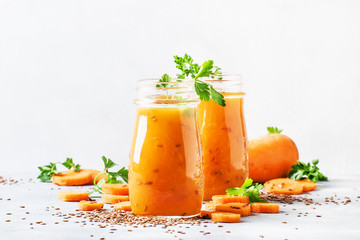 Carrot juice with flax seeds in glass bottles, healthy drink for raw diet, selective focus