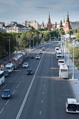 Cityscape of Moscow with road and buildings of Kremlin. Summer Moscow. Cars on the road to Kremlin.