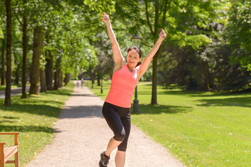 Happy fit woman cheering and celebrating