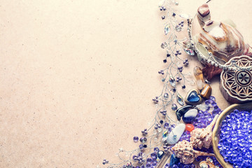 Beautiful stones, crystals, minerals, and other materials on a cardboard textured surface. Magic...